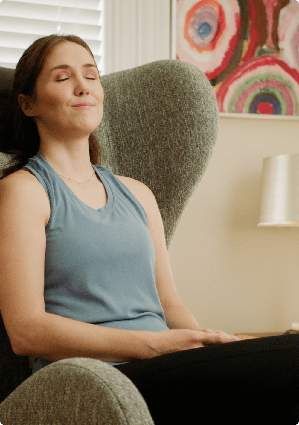 Woman relaxing with eyes closed in chair 